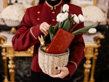 smartphone next to presents wrapped in red paper