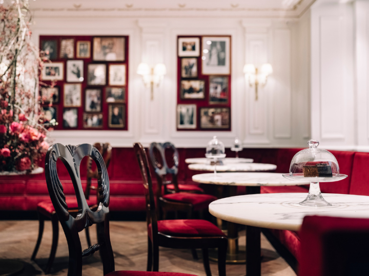 Elegant Café Sacher Salzburg with red velvet seating and classic Viennese coffeehouse charm.
